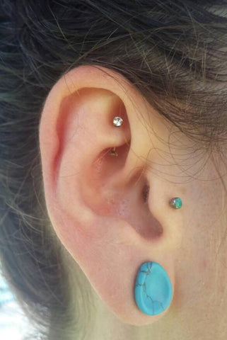 rook piercing with a titanium curved barbell and gems
