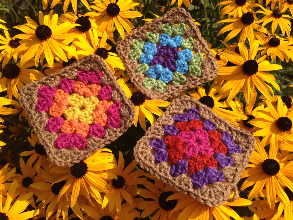 crocheted granny squares on top of black eyed susan flowers