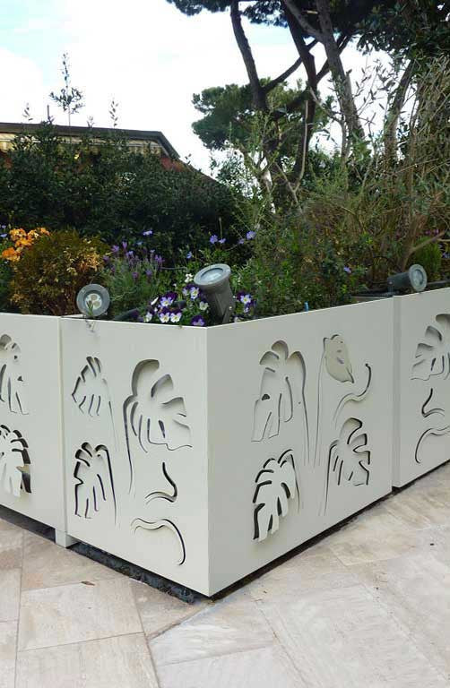 balustrade planters decorated on both sides with laser cut aluminum monstera leaves