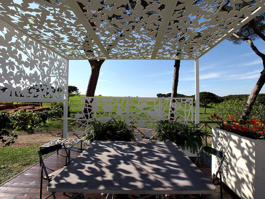 sun shade structure; laser cut aluminum screens with fig tree decoration