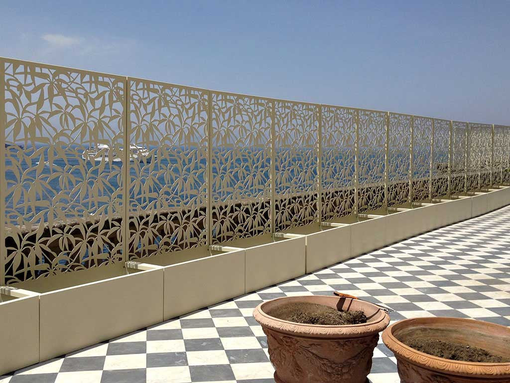 terrace overlooking the sea; laser cut aluminum screens with planters