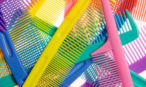 Lockdown afro hair care: Close up of layered colourful combs