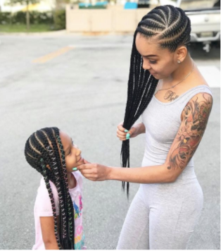 back to school hairstyles: young black girl with her mother sporting matching cornrow hairstyles
