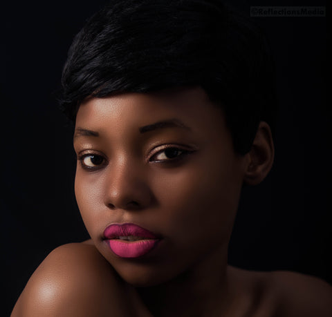 black woman with short relaxed hair and pink lipstick