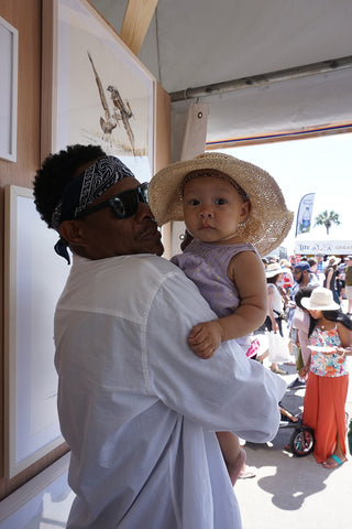 Corey Henry and daughter at Annie Moran art booth New Orleans Jazz and Heritage Festival 2019