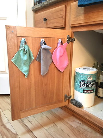 hanging norwex cloths behind cabinet door