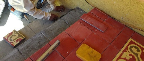 Install cement tiles with a narrow grout joint on a clean, level surface