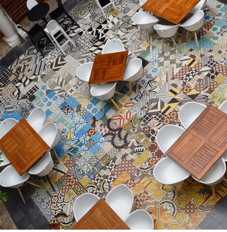Colorful and fun cement tiles are randomly placed to create a fun and interesting dining space for this restaurant