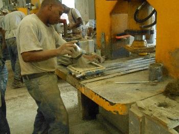 Sand is added to a cement tile by the tilemaker