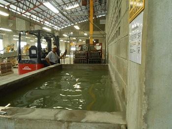 Cement tiles are placed in a water bath after being made