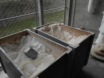 Calcium carbonate in these bins will be mixed to form the color layer