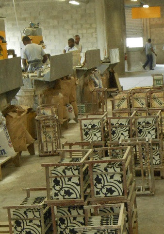 Cement tiles dry on metal racks at factory