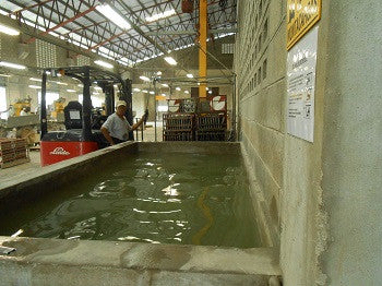 Racked cement tiles cure when lowered into a water bath.