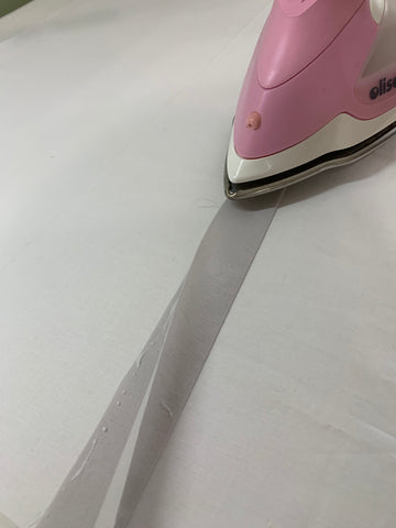 Add glue to the edge and iron with stream