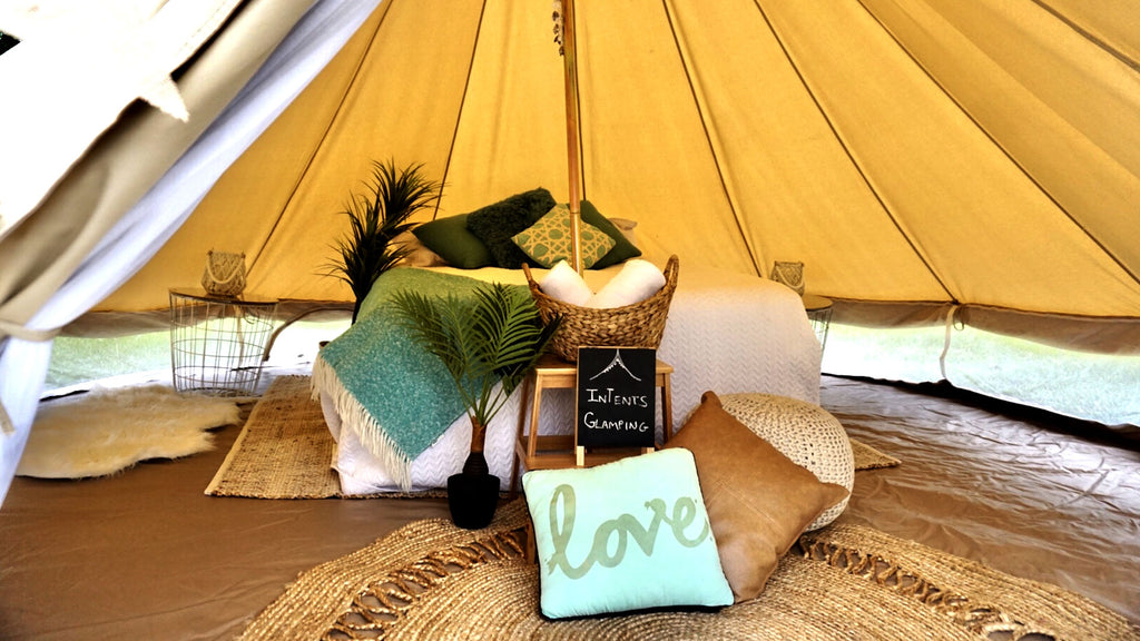 Inside of luxury glamping tent pillows blankets
