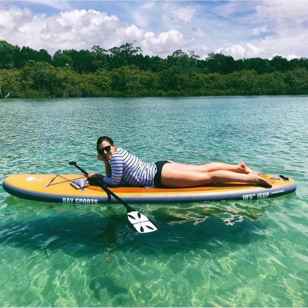 Woman lying on a paddle board
