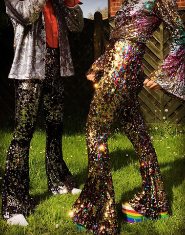 Man and woman wearing sequin flared trousers