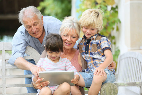 family with children and grandparents reading