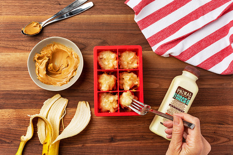 Primal Peanut Butter Pupsicles Step 3- Adding mashed banana to ice tray