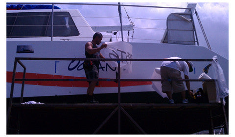 Boat vinyl graphic being installed