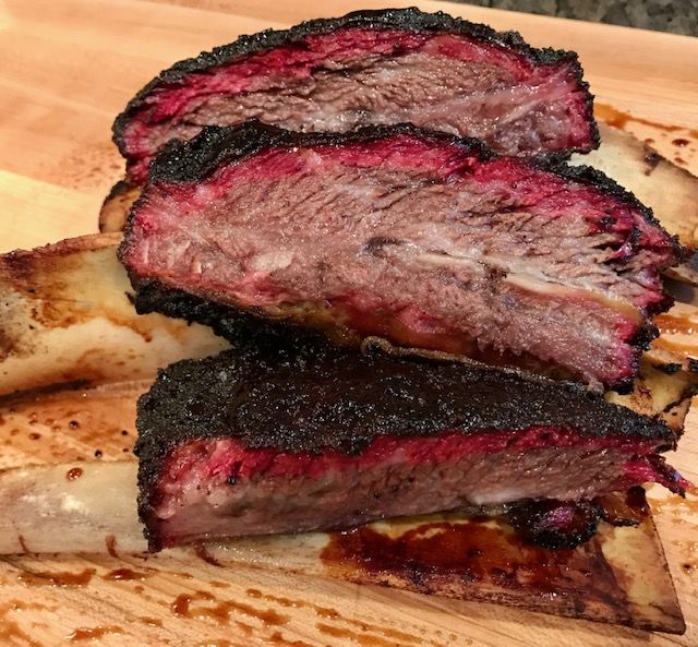 sliced up smoked beef short ribs showing a red smoke ring