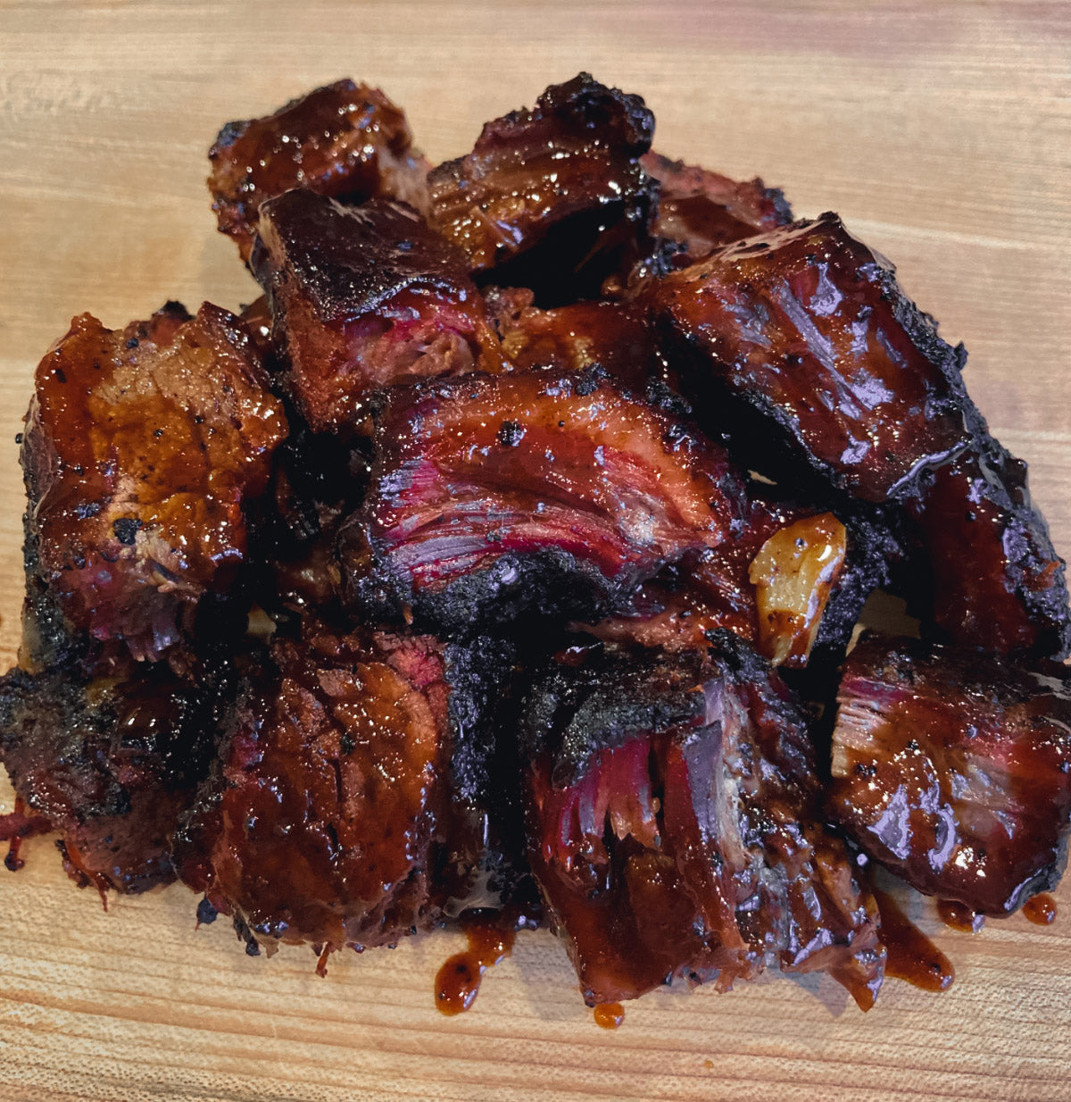 Photo of smoked brisket burnt ends covered in barbecue sauce