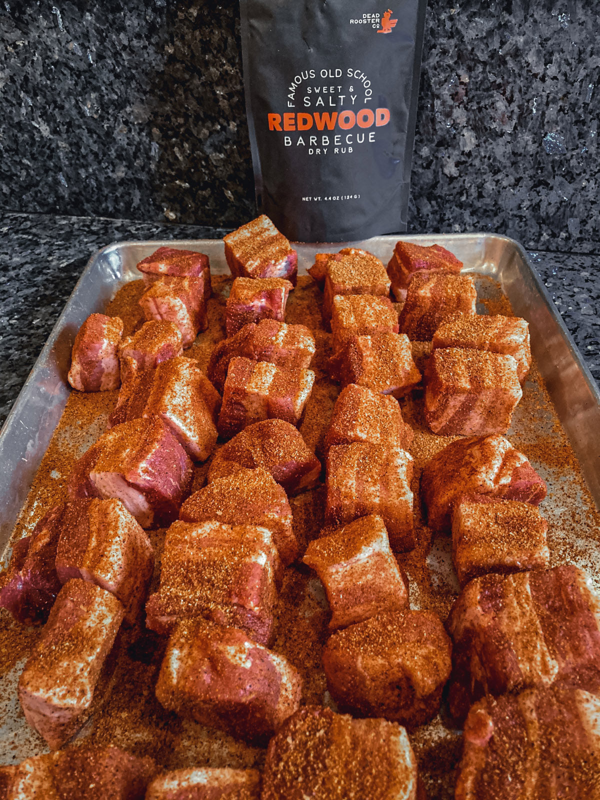 Photo of raw pork belly burnt ends covered in bbq flavored dry rub