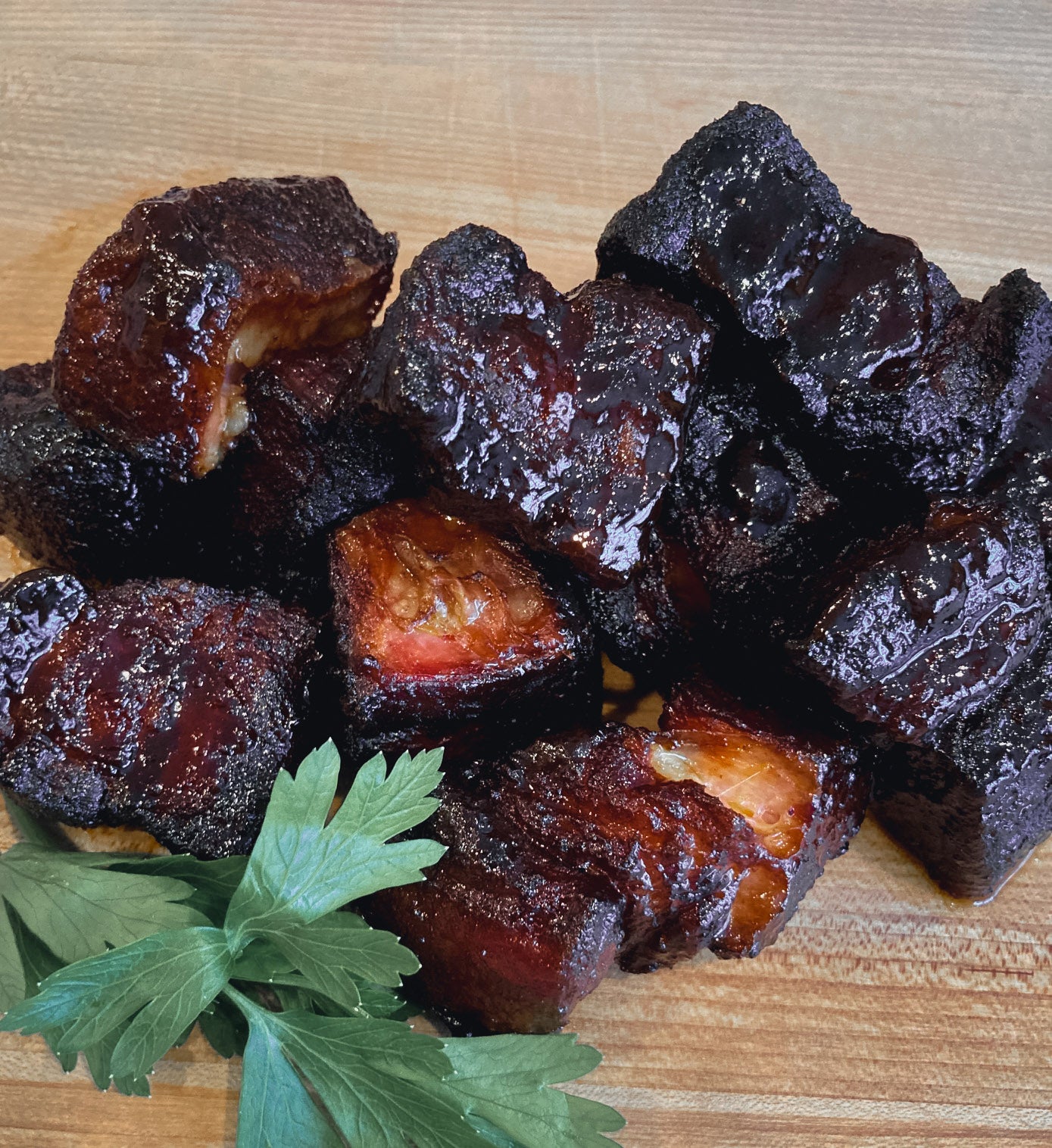 Photo of smoked pork belly burnt ends covered in barbecue sauce