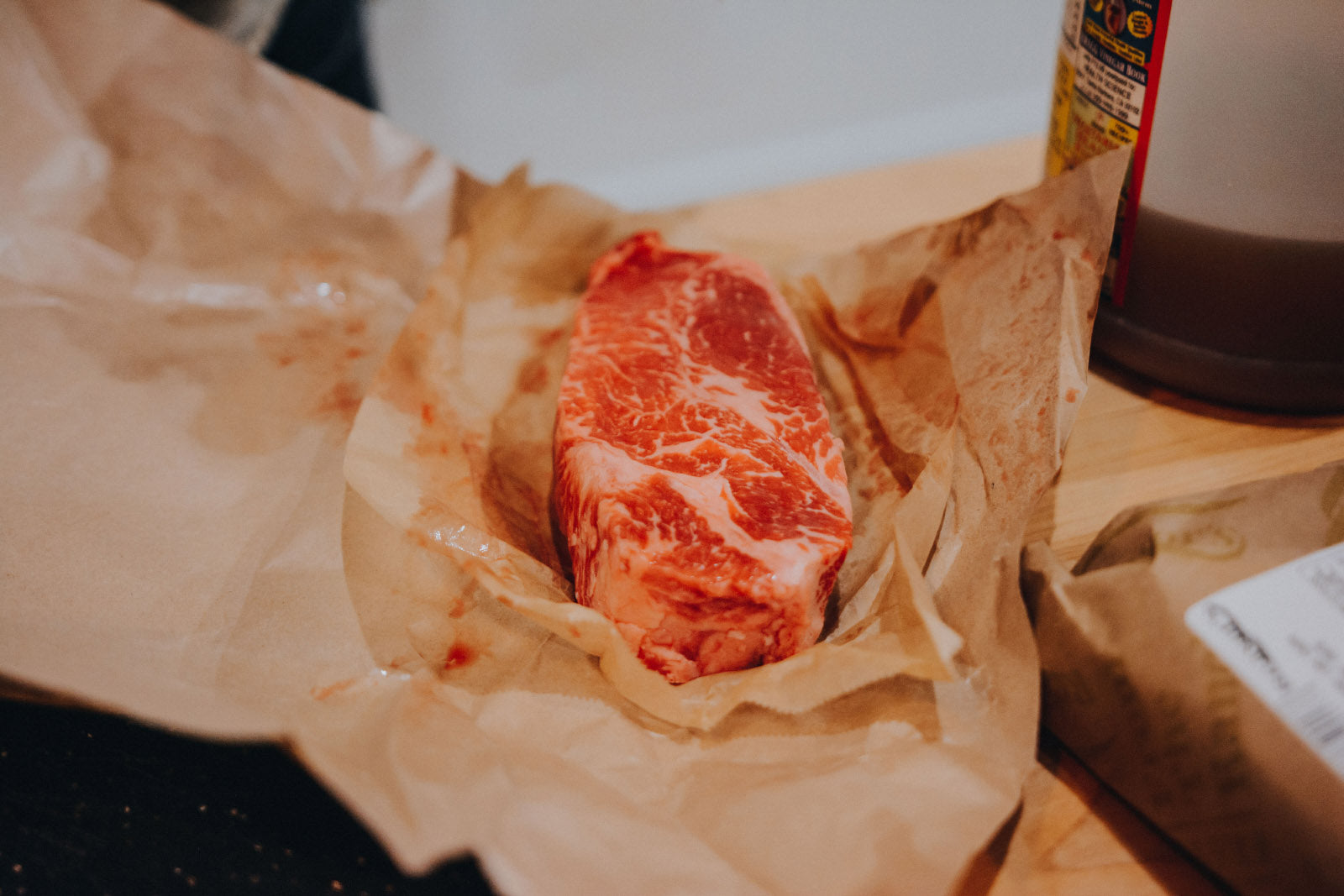 Raw steak in butcher paper