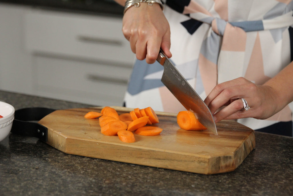 woman chopping carrots