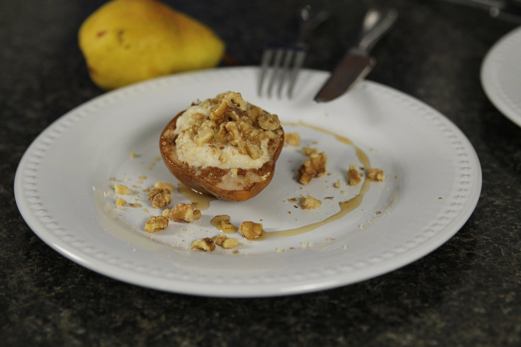 warm pear with ricotta maple and walnuts on plate