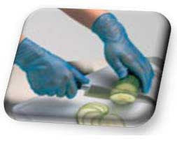 Hands cutting vegetables while wearing protective gloves
