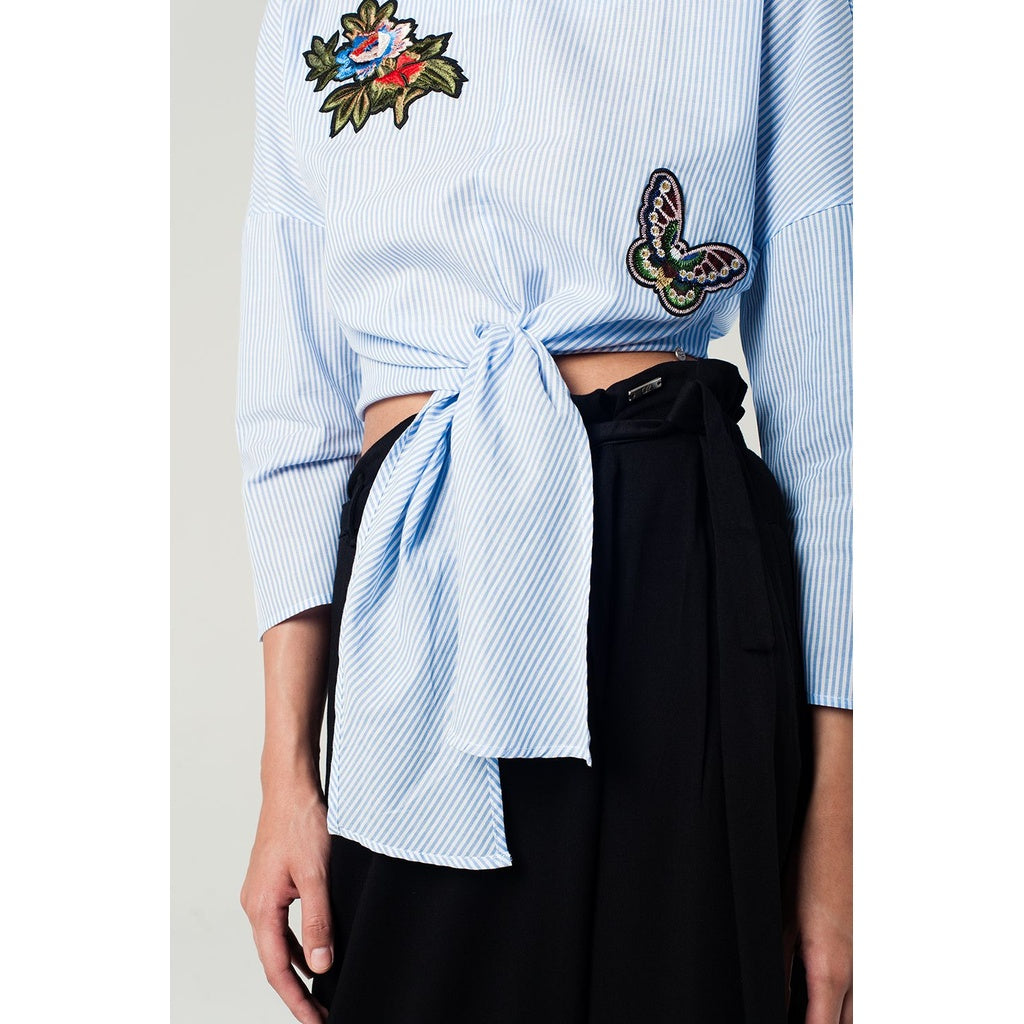 Blue striped top with embroidered patches detail