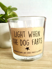 A candle that is light in color on top of a wooden table that says light when the dog farts | Bubu Brands 
