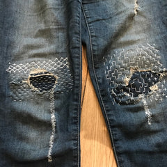 My daughter’s ripped jeans that were headed for the trash. Refreshed, embellished and strengthened by my human hand.