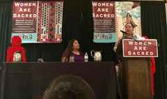 Amber Crotty, Navajo Nation Delegate delivers Keynote "We Carry Our Medicine" supported by Cherrah Giles, Board Chairwoman of National Indigenous Women's Resource Center (seated). 