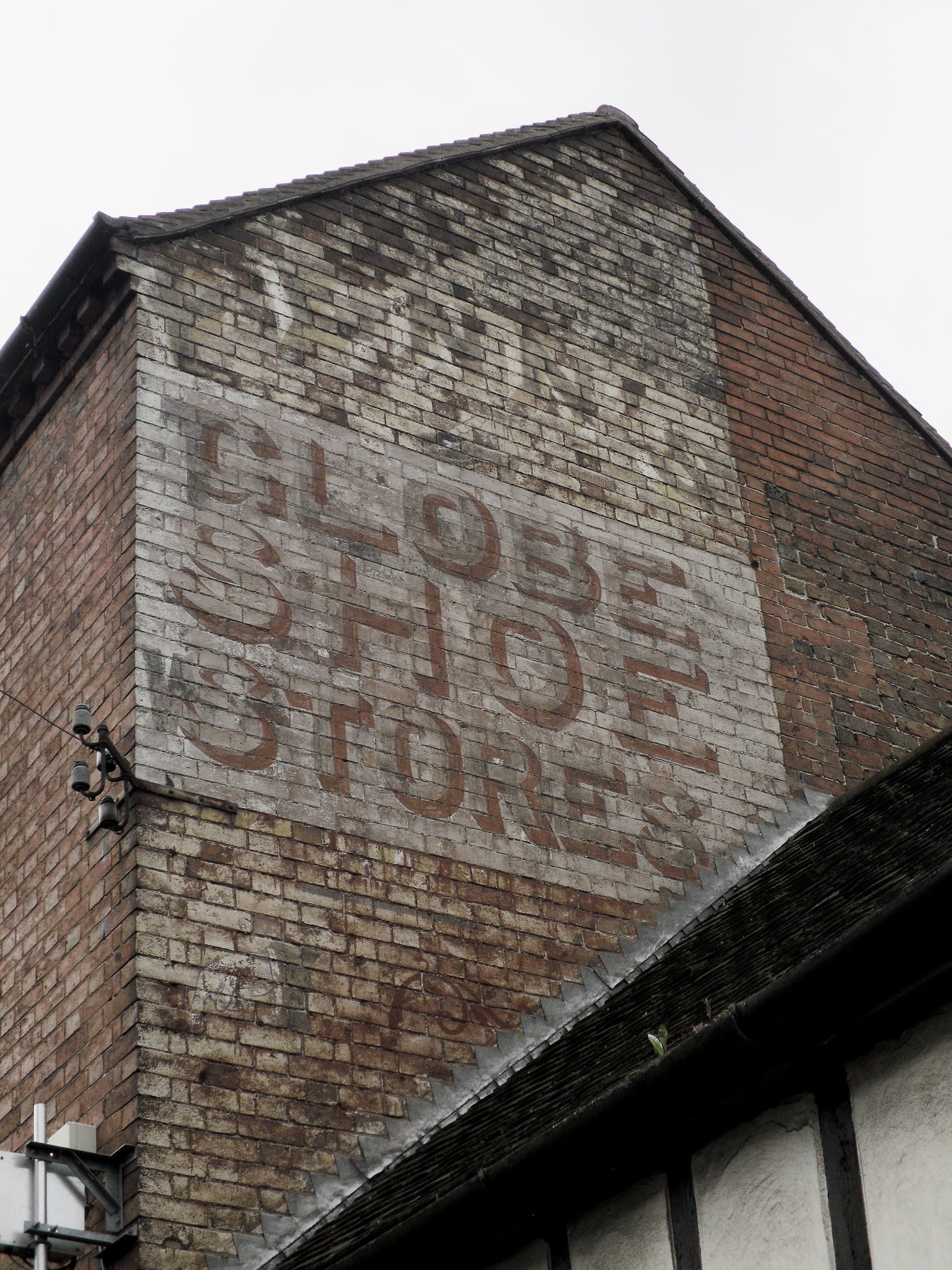 red brick building with faded ghost sign in Cincinnati Ohio