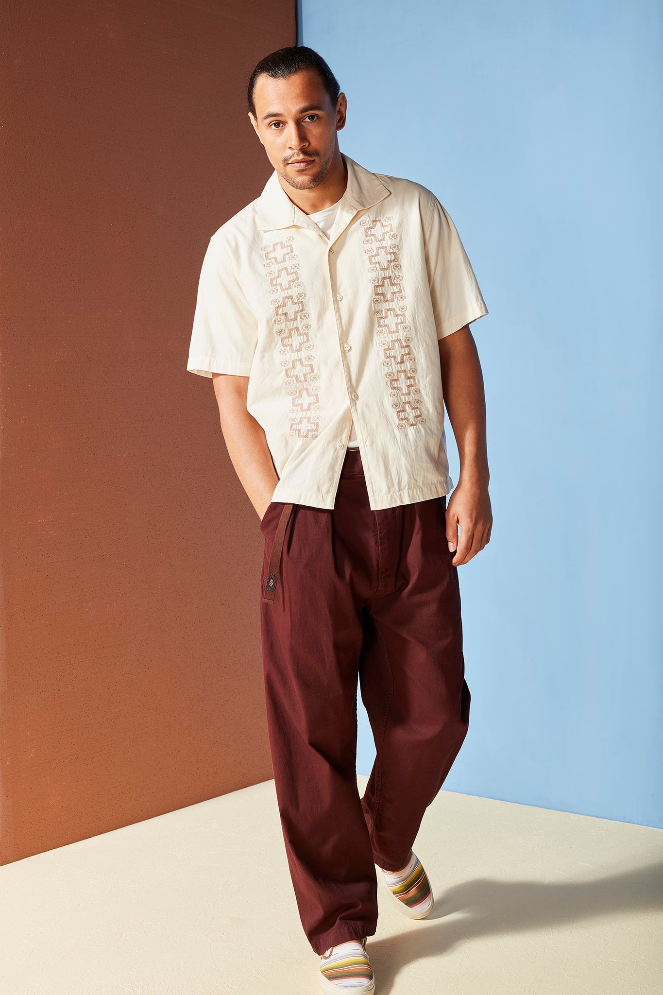 Embroidered white summer open collar shirt with red pleat trousers