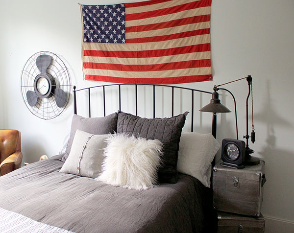 Metal bed frame with american flag on wall