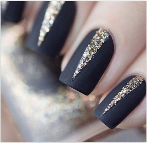 Sliver of glitter peeking out from these matte black nails.