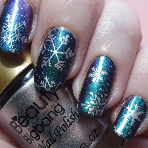 Glitte blue Christmas snowflake nail stamping design