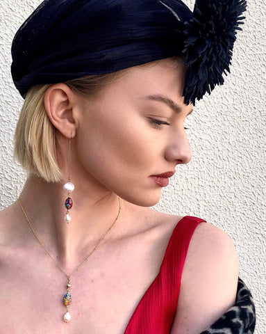 Image of model wearing Leoni & Vonk Venetian bead and pearl jewellery and a Murley & Co hat