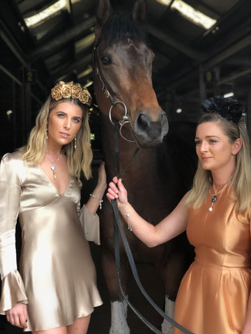 Image of Georgi Connolly and Belle Warren at Jason Warren Racing wearing Leoni & Vonk jewellery and Murley & Co millinery