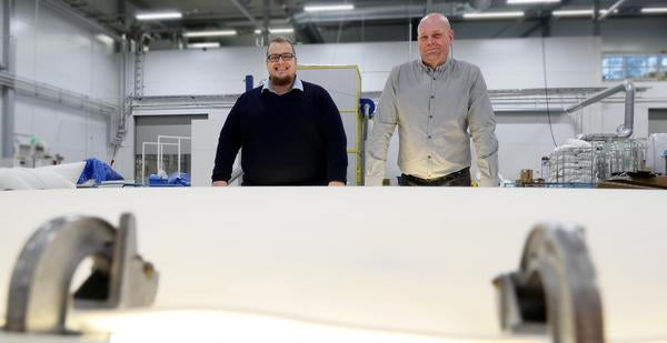 IT & LOGISTICS MANAGER SAMI SALONEN AND VICE PRESIDENT ERKKI JUHONEN WITH A DOWN DUVET AT THE COMPANY'S SEWING DEPARTMENT.
