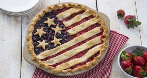 Homemade strawberry and blueberry pie with crust strips arranged as an American Flag over the top of the pie