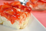 A slice of strawberry dessert with jellied topping