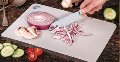 RADA Cutlery Flexible Cutting Board with a red onion and other sliced vegetables using our french chef knife