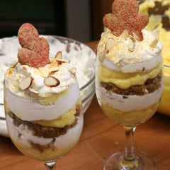 Two wine glasses with almond chips, gingerbread man and frosting topping