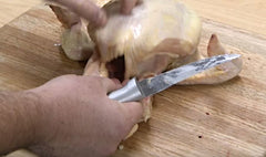 Chef Blake slicing through his chicken with a RADA Super Parer knife