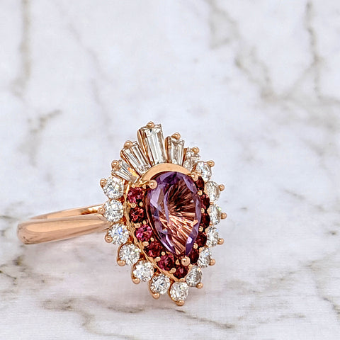 Custom Design: 18k Rose Gold with a pear cut Amethyst centre stone, pink tourmalines, and tapered baguette diamonds